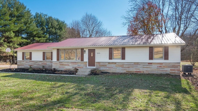 ranch-style home featuring central AC unit and a front yard