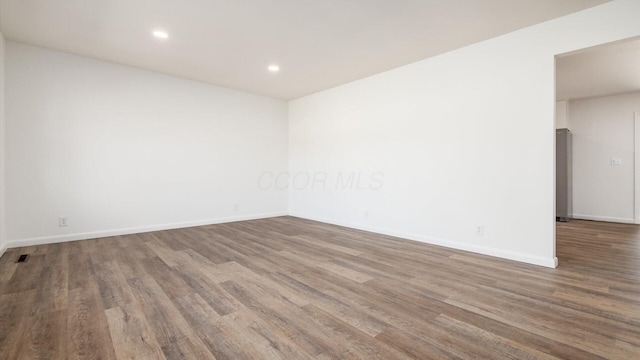 unfurnished room featuring wood-type flooring