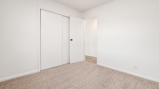 unfurnished bedroom with carpet and a closet