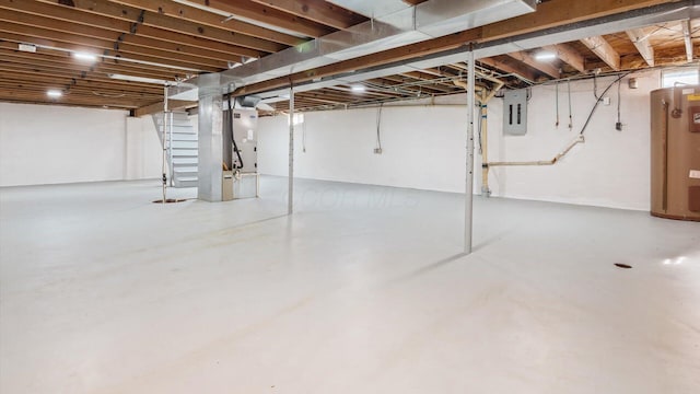 basement featuring electric panel and heating unit