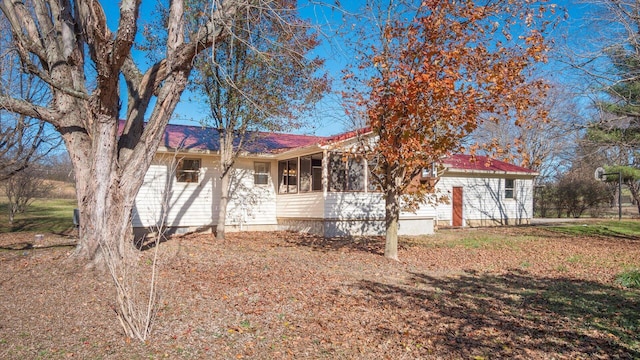 view of front of house featuring a sunroom