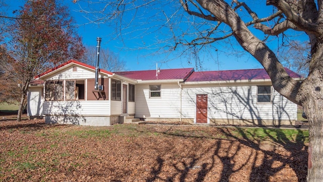 view of front of home featuring a sunroom