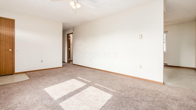 carpeted spare room with ceiling fan