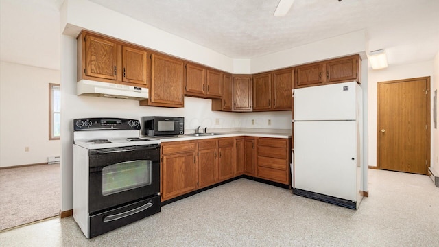 kitchen featuring a textured ceiling, sink, white appliances, and a baseboard heating unit