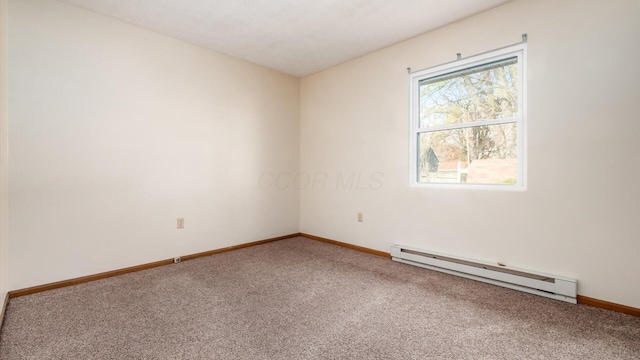 carpeted spare room featuring a baseboard radiator