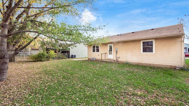 back of property featuring a yard