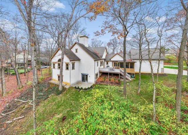 rear view of house with a yard and a wooden deck