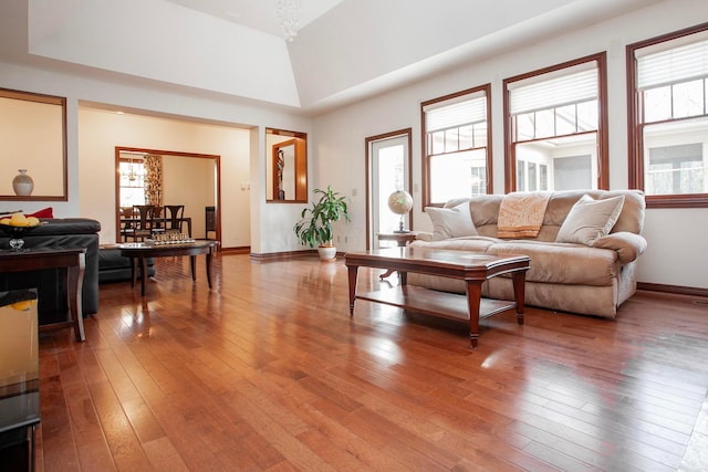 living room featuring a chandelier, wood-type flooring, and a wealth of natural light