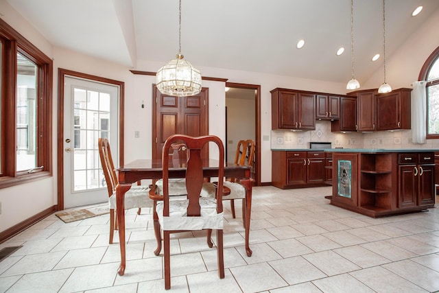 dining room featuring light tile patterned floors, high vaulted ceiling, and an inviting chandelier