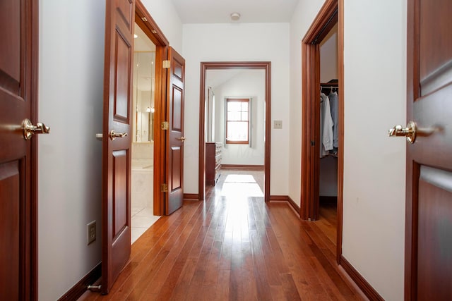 hallway with light hardwood / wood-style flooring