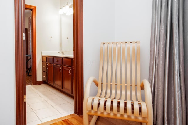 bathroom featuring tile patterned floors, vanity, and a notable chandelier