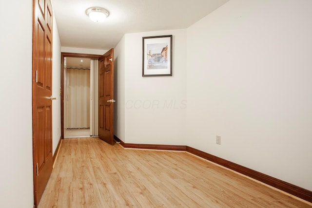 corridor with light wood-type flooring