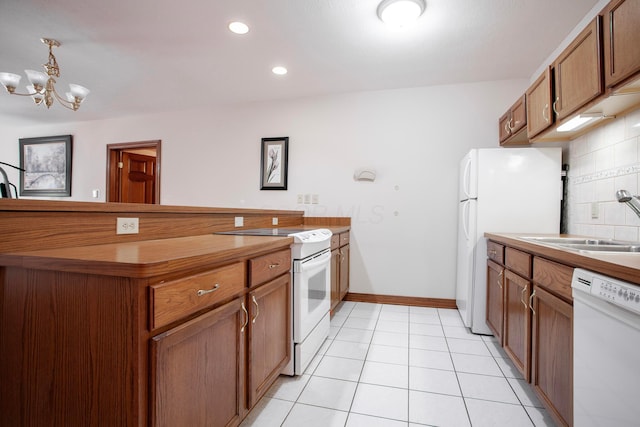 kitchen featuring white appliances, backsplash, an inviting chandelier, sink, and decorative light fixtures