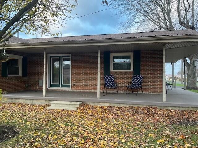 rear view of house featuring a porch