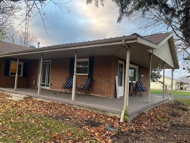 rear view of property with covered porch