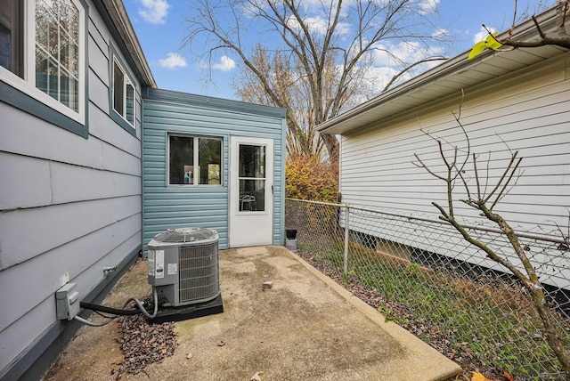 doorway to property with central air condition unit and a patio