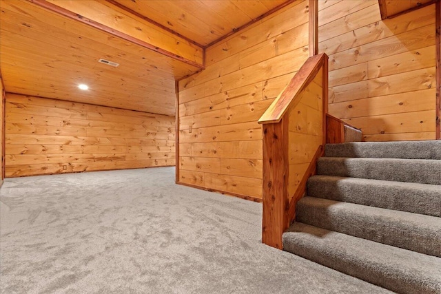 bonus room featuring carpet flooring, wooden walls, and wood ceiling