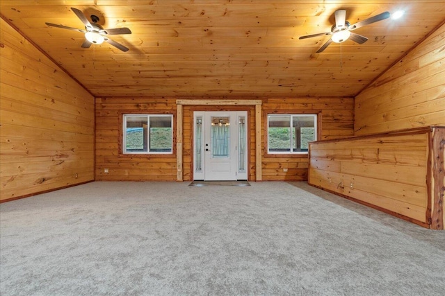 interior space with carpet, lofted ceiling, wood ceiling, and wooden walls