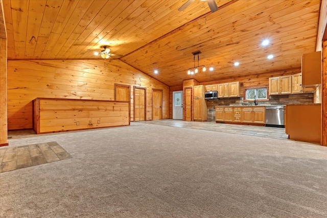 unfurnished living room with wooden ceiling, sink, wooden walls, vaulted ceiling, and light colored carpet