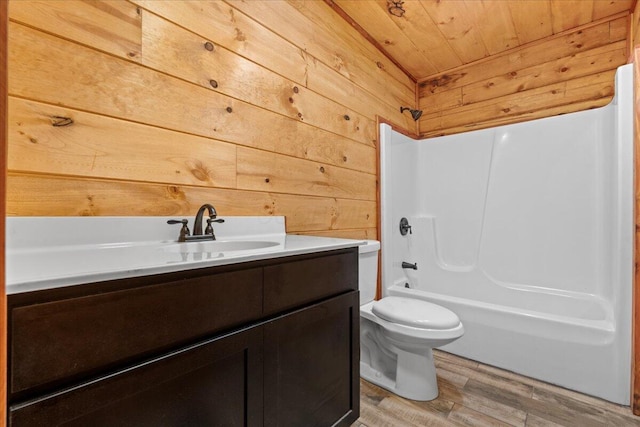 full bathroom with wood ceiling, vanity, shower / bathing tub combination, hardwood / wood-style flooring, and toilet