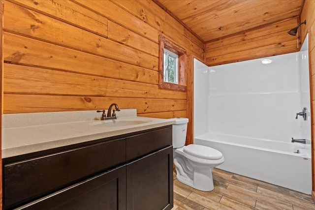 full bathroom featuring wood ceiling, vanity, wooden walls, hardwood / wood-style floors, and toilet