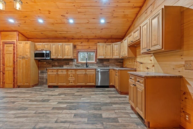 kitchen with wooden walls, wooden ceiling, hardwood / wood-style flooring, and appliances with stainless steel finishes