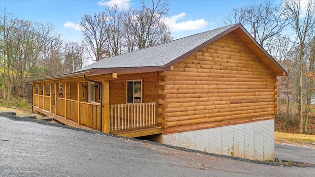 view of side of home with covered porch