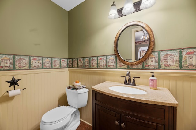 bathroom featuring vanity, lofted ceiling, and toilet