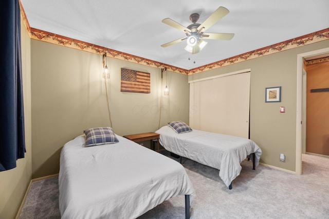 bedroom with ceiling fan, carpet floors, and a closet