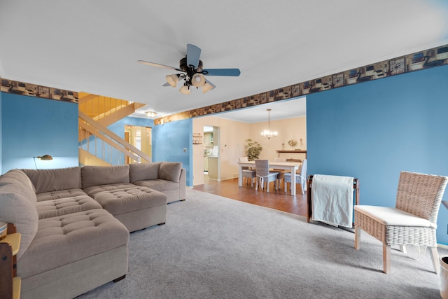 living room with carpet and ceiling fan with notable chandelier