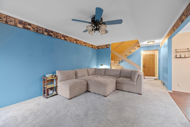 carpeted living room with ceiling fan and ornamental molding