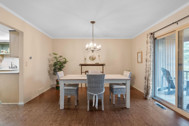 dining area with a wealth of natural light, ornamental molding, dark hardwood / wood-style floors, and a notable chandelier