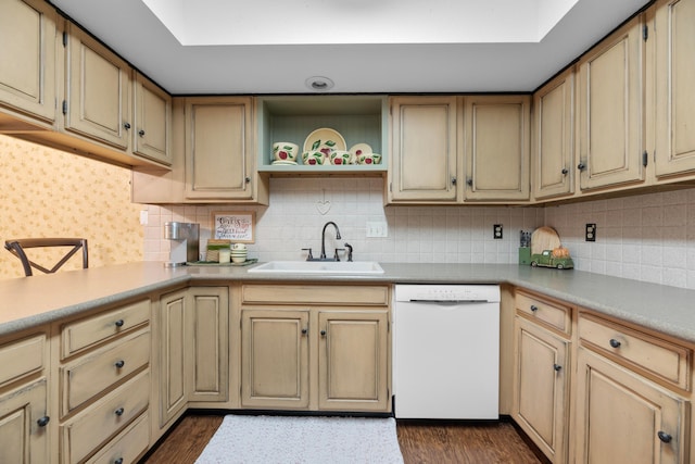 kitchen with tasteful backsplash, sink, white dishwasher, and dark hardwood / wood-style floors