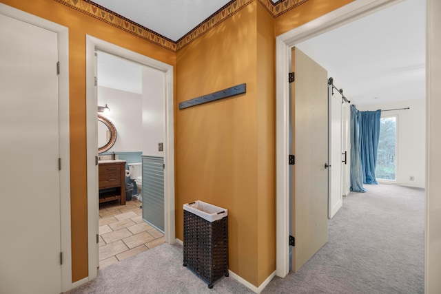 hallway featuring light colored carpet