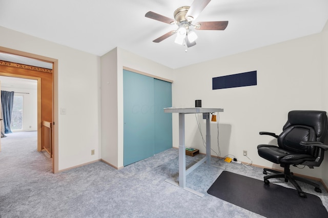 carpeted office featuring ceiling fan