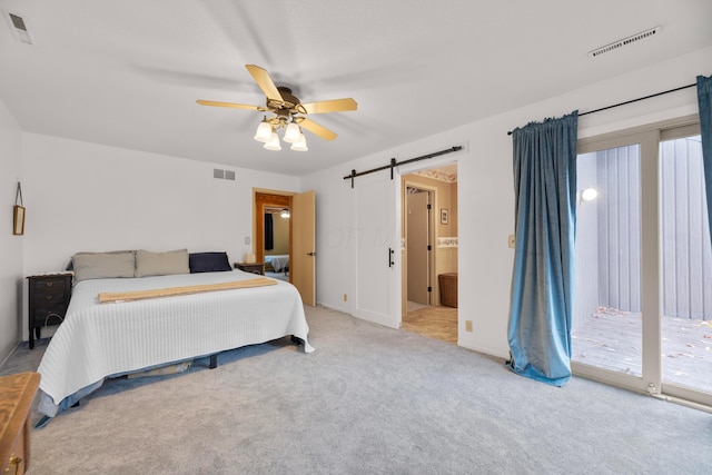 bedroom with ceiling fan, a barn door, access to exterior, and carpet floors