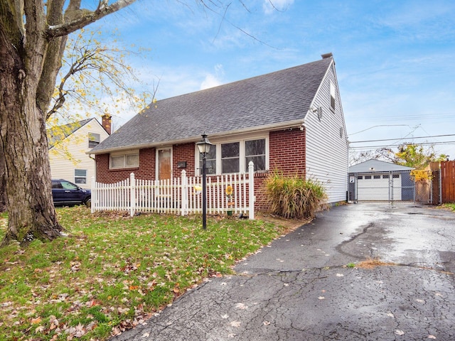 view of front of home with an outbuilding, a garage, and a front lawn