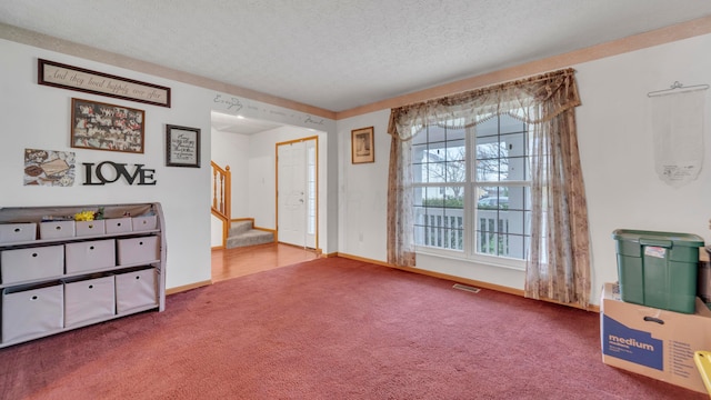 interior space with carpet flooring and a textured ceiling