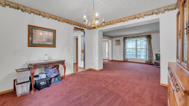 interior space with carpet, a chandelier, and a textured ceiling