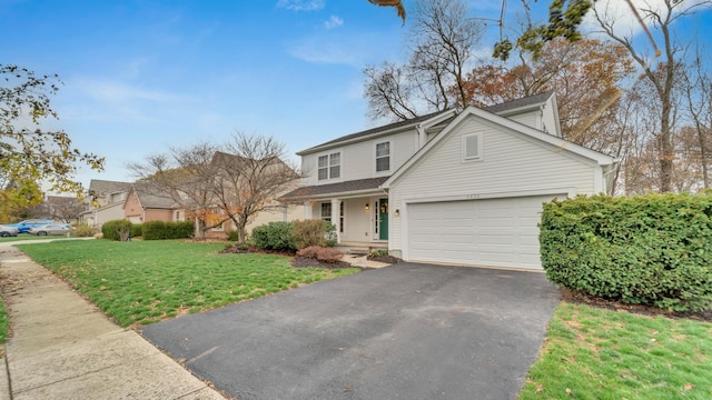 view of front property featuring a garage and a front lawn