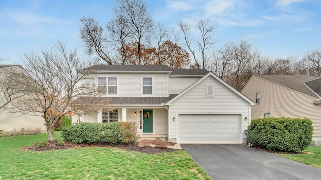 view of property with a front yard and a garage