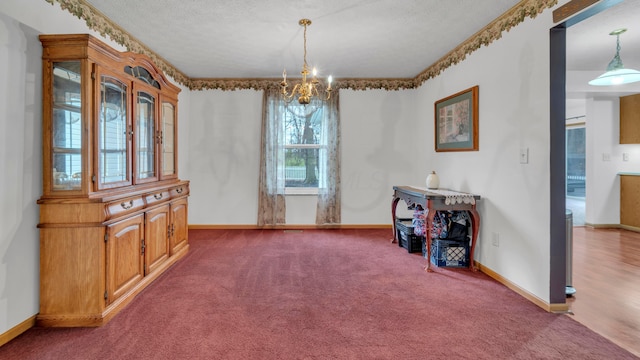 interior space featuring a notable chandelier and a textured ceiling