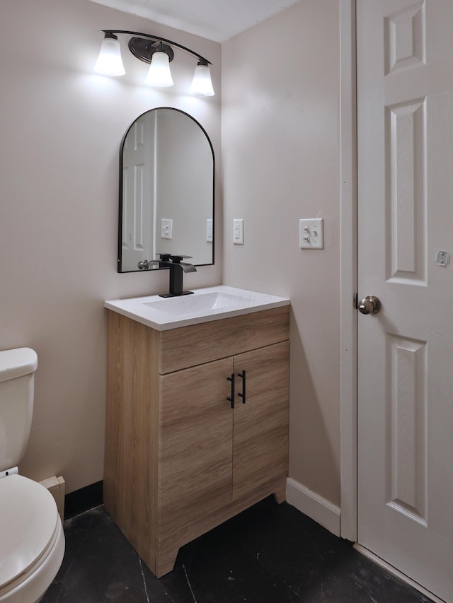 bathroom featuring tile patterned flooring, vanity, and toilet