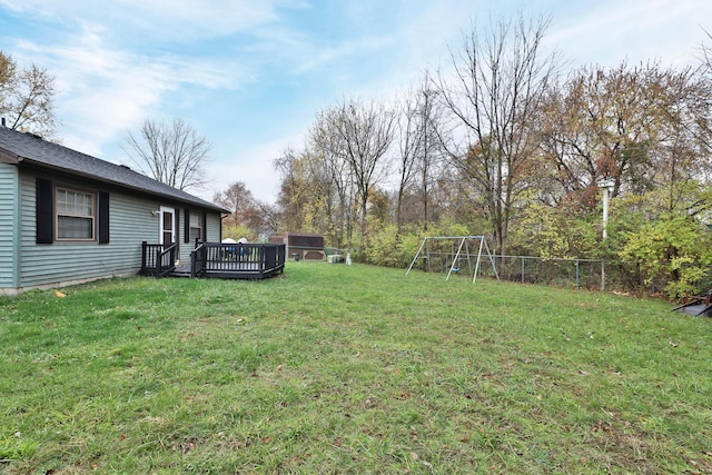 view of yard featuring a playground and a deck