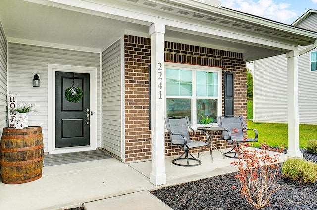 view of exterior entry with covered porch