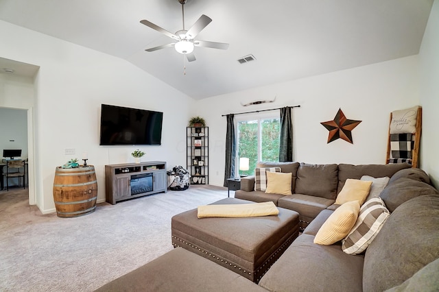 carpeted living room featuring ceiling fan, a fireplace, and vaulted ceiling