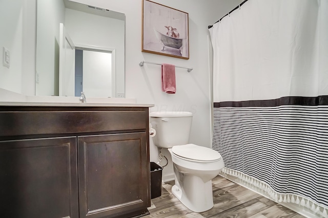 bathroom with vanity, hardwood / wood-style flooring, and toilet