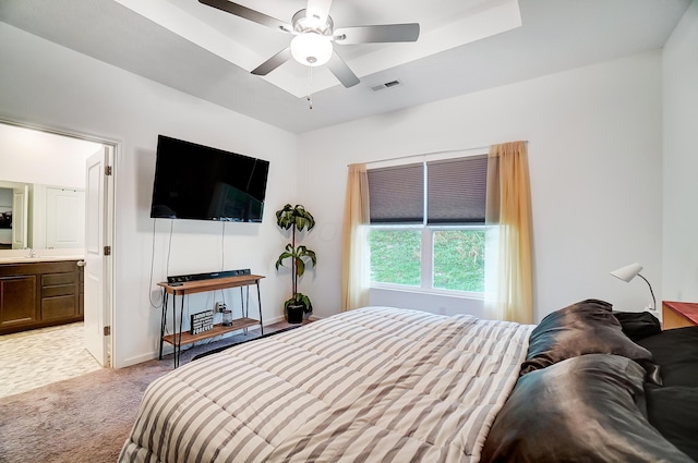 carpeted bedroom with connected bathroom, ceiling fan, and sink