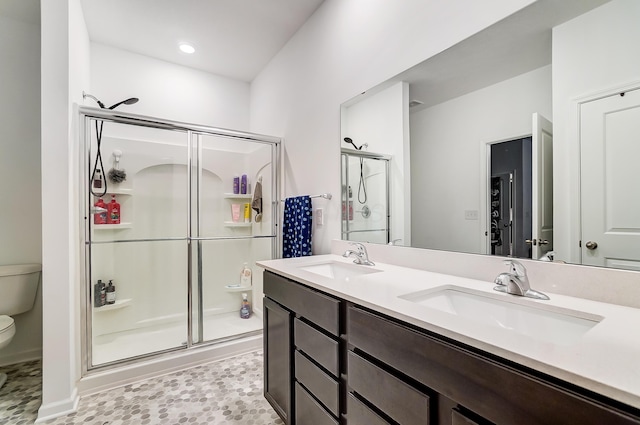 bathroom with toilet, vanity, and walk in shower