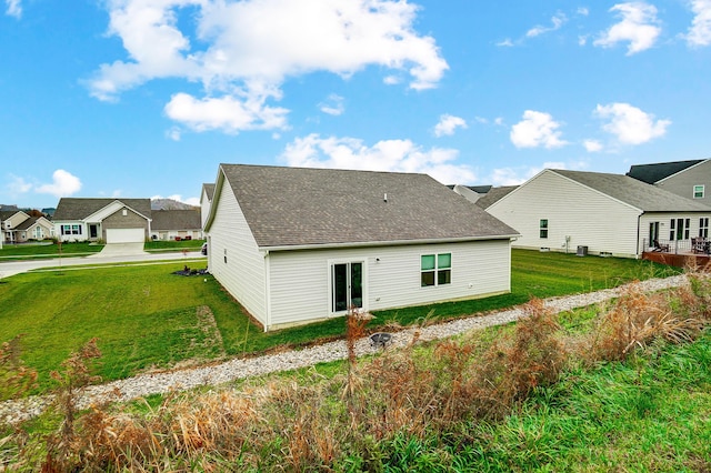 back of property featuring a lawn